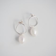 Our Wobble Earrings | Pearls are a perfect statement earring. With organic minimalist shapes, this pair is destined to be the focal point of any outfit. Our Wobble Earrings | Pearls have a lovely movement allowing the pearls to flutter below your ear. Perfect for those who love all things minimalist and make a lovely gift to your bridesmaid, bestie or even as a special treat to yourself. DETAILS ~ ear post and butterfly back fixture ~ pearls approximately measure 12mm ~ all pearls vary in shape and colour. We can not guarantee that any two will be alike or exactly like the pictures shown. Pearls are very delicate, take care of these babies. ~ total drop length is approximately 3cm ~ available in Sterling Silver, 9ct Yellow Gold and 9ct White Gold ~ is your order a gift? a handwritten note Modern White Pearl Earrings For Everyday, Handmade Minimalist Pearl Earrings For Everyday, Handmade Minimalist Pearl Earrings, Minimalist Handmade Pearl Earrings For Everyday, Minimalist Shapes, Dainty Jewellery, Silver Pearl Earrings, Statement Earring, Professional Jewelry