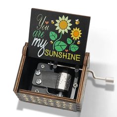 an open music box with sunflowers painted on the front and sides, saying you are my sunshine