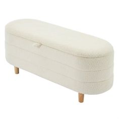 an upholstered bench with wooden legs and footrests, in white fabric