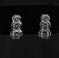 Three Stone Earrings, Genuine Diamond Earrings, Vintage Earrings, 14K White Gold Earrings, Natural Diamond Stud Earrings, Estate Earrings, Everyday Earrings, Elegant Earrings. This vintage pair of earrings is crafted in solid 14K White Gold Three round cut diamonds are .20ct, .15 carat, and .10 carat each = .90 total diamond weight. The diamonds are very clean VS2 clarity and H color. The earrings measure 11mm from top to bottom. They are equipped with long posts and butterfly backs. The pair we Three Stone Diamond Earrings As Gift, Classic Brilliant Cut Clip-on Earrings For Anniversary, Classic Brilliant Cut Clip-on Earrings For Formal Occasions, Classic Brilliant Cut Clip-on Earrings For Formal Events, Classic Anniversary Clip-on Earrings With Diamond Accents, Classic Formal Clip-on Earrings With Brilliant Cut, Classic Formal Brilliant Cut Clip-on Earrings, Three Stone Diamond Earrings In Fine Jewelry Style, Three-stone Diamond Earrings For Wedding