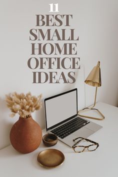 a laptop computer sitting on top of a white desk next to a vase with flowers