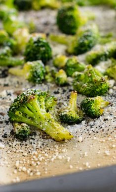 broccoli florets on a baking sheet with seasoning sprinkles