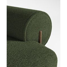 a green chair with a wooden stick sticking out of it's backrests