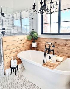 a white bath tub sitting in a bathroom next to a window