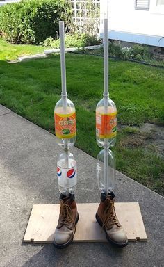 two water bottles that have been placed on top of each other in front of a house