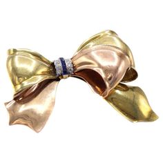 Check out this item from 1stdibs! Cartier Retro Sapphire Diamond Two Color Gold Bow Brooch: https://www.1stdibs.com/id-j_21902142 Antique Cartier Jewelry For Gifts, Elegant Yellow Gold Brooches For Party, Elegant Yellow Gold Party Brooches, Elegant Anniversary Brooch With Bow, Luxury Yellow Gold Brooches For Parties, Elegant Brooches With Decorative Bow For Anniversary, Elegant Anniversary Brooch With Decorative Bow, Elegant Anniversary Brooches With Decorative Bow, Elegant Rose Gold Brooches For Anniversary