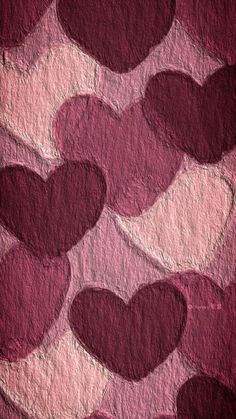 many hearts are arranged in the shape of heart shapes on a textured paper background