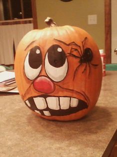 a pumpkin with a creepy face painted on it