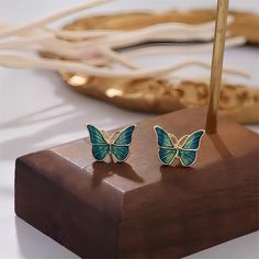 Description: Enamel Butterfly Earrings Specifications:Size: 13 mm * 10 mmWeight: 5 g/pairMaterial: Copper, Enamel, GoldColor: Green Add some fun and whimsy to your outfit with our Enamel Butterfly Earrings! Perfect for any occasion, these quirky earrings are sure to make a statement. Fly into style with these unique accessories. Symbol Of Happiness, Small Clouds, Enamel Butterfly, Stud Earrings Unique, Quirky Earrings, Daily Jewelry, Green Butterfly, Butterfly Earrings, Accessories Unique