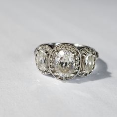 Gorgeous Tacori Three Stone Ring. It Features Crown Mountings & Inset Diamonique Stones. The Band Has Elegant Vines Etched Along It. There Is Also Antique Style Milgrain Work That Adds Even More Sparkle And Beauty. The Center Stone Is .50 Carat And The Side Blooms Are .20 Cts Each. This Is Breathtaking And Made To Last. Hallmarked Tacori 925 Size 6 Other Listings: Modern, Antique, Vintage, Art Nouveau, Art Deco, Artisan, Designer, Minimalist,10k, 14k, 18k, Gold, Platinum, Sterling Silver, Rhodium, Solitaire, Cluster, Diamonds, Sapphires, Aquamarine, Garnets, Turquoise, Rubies, Quartz, Moonstone, Onyx, Tourmaline, Zircon, Jade, Topaz, Apatite, Ametrine, Tanzanite, Emeralds, Onyx, Pearls, Ku Timeless White Gold Jewelry With Rose Cut Diamonds, Classic White Gold Jewelry With Rose Cut Diamonds, Heirloom White Topaz Jewelry In White Gold, Elegant Oval Jewelry With Center Stone, Elegant Sterling Silver Diamond Ring With Rose Cut, Exquisite Silver Wedding Ring With Halo Setting, Timeless Silver White Topaz Rings, Exquisite Silver Halo Setting Wedding Jewelry, Luxury Oval Rose Cut Diamond Jewelry