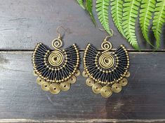 GET 15% OFF RIGHT NOW, BY SUBSCRIBING TO OUR MAILING LIST VIA OUR WEBSITE (WWW.JASPER-ROCKS.COM) & PURCHASING THERE. So statement, so simple! So Egyptian queen. We have created these absolutely stunning black macramé gold spiral earrings for you, go no further than these showstopping, versatile beauties!  Intricate black macrame adorns hammered brass wire, which has been graced by suspended golden spirals, also with a hammered metal patina. For pierced ears, these boho earrings have been lovingl Adjustable Bohemian Wrap Earrings For Party, Black Handwoven Jewelry For The Beach, Handwoven Black Jewelry For The Beach, Black Handwoven Jewelry For Beach, Bohemian Gold Spiral Wrap Earrings, Adjustable Bohemian Beaded Wrap Earrings, Adjustable Bohemian Wrap Earrings For Festivals, Gold Bohemian Wrap Earrings For Festivals, Bohemian Gold Wrap Earrings For Festival