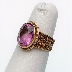 This is a beautiful Victorian era 13k gold (tested) and natural amethyst Etruscan revival ring. The amethyst measures 11mm x 7mm. The piece is in excellent antique condition with no visible flaws. The ring is a US size 4.5 and weighs 2.7 grams. If you have any questions or would like to see additional pictures, please contact us before making your purchase. Buyers outside the United States, please contact us for a shipping estimate. Gold Amethyst Rings With Rose Cut Diamonds, Formal Amethyst Ring With Rose Cut Diamonds, Amethyst Ring With Rose Cut Diamonds, Oval Shape, Round Amethyst Ring With Rose Cut Diamonds, Purple Amethyst Ring With Rose Cut Diamonds, Victorian Yellow Gold Amethyst Gemstone Ring, Victorian Yellow Gold Amethyst Ring, Victorian Oval Amethyst Ring With 17 Jewels, Victorian Style Hallmarked Amethyst Ring