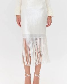 Sequin, midi skirt rendered in a clean white. The skirt is most noticeable for it's sequin, fringe hem. It's a classic design that's made to stand out. Midi Skirt Fringe Sequin Lined Length: 33 1/2" Waist 13 3/4" Self: 95% Polyester 5% Spandex Lining: 100% Polyester Model is wearing a size S Return Policy ALL regular price items may be returned for a store credit. Items must be received by us within 14 days. Item must still have tags on and be unworn. ***JEWELRY, handbags, lingerie, scarves, swi Sequin Fringe Skirt, Sequin Midi Skirt, Discount Promotion, Fringe Skirt, Stay Classy, Sweater Coats, Denim Dress, Classic Design, Sweater Top