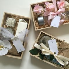 three gift boxes with flowers and labels on them