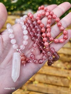 Hand Knotted Rose Quartz, Golden Strawberry Quartz & Thulite 108 bead Mala An amazing and rare treasure; a hand knotted free-form rose quartz pendant stone with a stunning variety of rose quartz, golden strawberry quartz & thulite polished 6mm beads. Unique find & one of a kind Hand made, sourced and designed in Canada. It is my intention that you feel happy, secure & well when wearing any of my items, and that they serve as a visual reminder to be kind to yourself & laugh often. Contact me for any gift packaging, custom inquiries, bulk orders or questions & I'd be happy to work with you on finding a solution. Ships within 1-2 days, pickup is free if you are in the Cambridge, Ontario area. Pink Spiritual Crystal Gemstone Necklace, Pink Spiritual Gemstone Crystal Necklace, Spiritual Pink Gemstone Crystal Necklace, Rose Quartz Gemstone Beads Crystal Necklace, Rose Quartz Gemstone Beaded Necklace, Rose Quartz Crystal Necklace With Gemstone Beads, Rose Quartz Crystal Necklace With Round Gemstone Beads, Handmade Pink Spiritual Crystals, Pink Rose Quartz Crystals For Spiritual Use