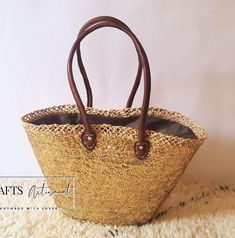 stunning Straw Bag with Leather Handle--a practical yet effortlessly stylish accessory for your sunny beach getaways. Crafted with care, our big sequin bag is intricately woven from natural palm leaves, exuding an air of elegance. Its rolled leather handles add a touch of sophistication, while the overlay of silver sequins lends it a dreamy and romantic appeal. This large silver sequin bag is designed to turn heads with its unique features, offering both style and comfort as you carry your essentials during beach trips or shopping excursions. Versatile enough for everyday use, it's an ideal companion for any occasion. Approximately sized at 40 cm in width, with a base of 18 cm and a height ranging from 27 cm to 30 cm, this straw basket bag boasts dimensions that are as unique as its handma Moroccan Market, French Basket, Moroccan Basket, Tote Bag Beach, Sequin Bag, Market Bags, Straw Basket, Bag Stand, Sunny Beach