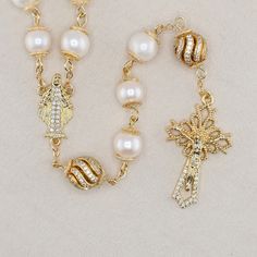 The perfect gift for newlyweds, couples, or anyone who wants a rosary they can pass on to their children. An heirloom piece that's beautiful, elegant, unique, and ornate. This beautiful handmade Catholic Rosary is made with 8mm and 10mm natural genuine Freshwater Pearl beads and 14K gold-plated metal findings. The total length of this rosary is approximately 27 inches and fits perfectly inside the box. The box is made of metal and enamel with velvet inner lining. What you see is what you get.  This Rosary comes with: 1 Enamel Metal Box 1 Microfiber Pouch  1 Microfiber Cleaning Cloth  1 Mini Holy Water Bottle 1 Bookmark   Note: This item ships separately and cannot be combined with other orders Rose Gold Jewelry For Christmas Wedding, Elegant Gold Rosary For Gift, Elegant Gold Rosary As Gift, Gold Wedding Jewelry Gift, White Spiritual Jewelry For Celebration, White Gold Jewelry For Christmas Wedding, White Gold Jewelry For Wedding Gift, Spiritual Gold Rosary For Wedding, Elegant Silver Rosary As Gift