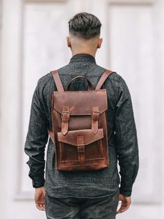 Check out our OTHER PRODUCTS https://www.etsy.com/shop/BartBag Model Simon: Compact, stylish backpack made of genuine leather with vintage style scuffs. It will match any style and occasion - it looks great both with оjeans and sneakers or dress. It is compact and roomy at the same time. * Backpack size: 10 x 14 x 4.3 '' / 25 x 35 x 11 cm. * Outer zippered pocket with the buckle: 8.3 x 5 '' / 21 x 13 cm. * Inside pocket on the back side: 7 x 6 '' / 18 x 15 cm. The main compartment closes with fa Casual Leather Backpack For Business, Rugged Leather Rectangular Backpack, Rugged Leather Satchel Backpack, Rugged Leather Standard Backpack, Classic Satchel Backpack With Leather Backing, Classic Leather-backed Satchel Backpack, Leather School Backpack With Leather Lining, Classic Leather Backpack For School With Leather Lining, School Leather Backpack With Soft Leather