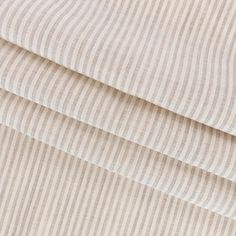 a close up shot of the fabric on a bed sheet that has been made with ticking stripes