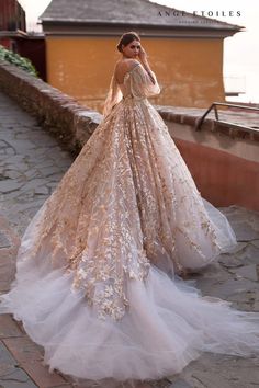 a woman in a wedding dress is standing on the street with her hands behind her head