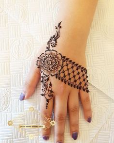 a woman's hand with henna on it