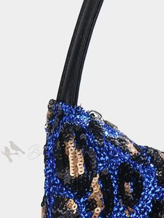 a blue and black purse with sequins on it