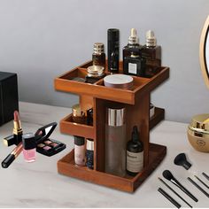 an assortment of cosmetics and makeup products on a table with a clock in the background