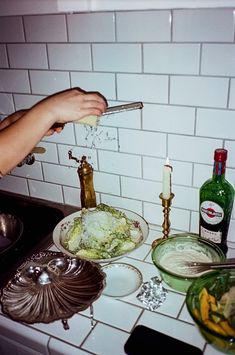 a person is sprinkling some food on the counter