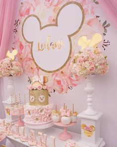 a pink and gold minnie mouse birthday party with lots of cake, decorations and desserts