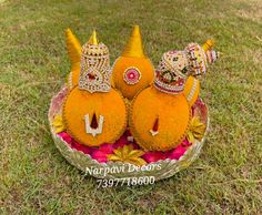 three decorative pumpkins in a basket on the grass