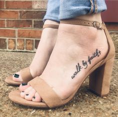 a woman's foot with the words walk by faith tattooed on her left ankle