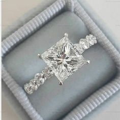 an engagement ring in a box with diamonds