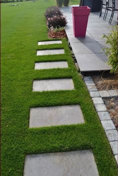 a walkway made out of stepping stones in the grass