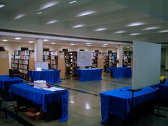 tables covered with blue tablecloths in a library