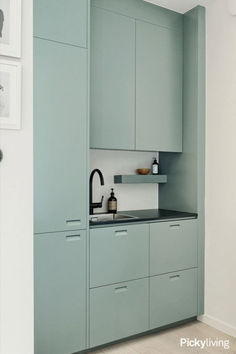 a kitchen with blue cabinets and white walls