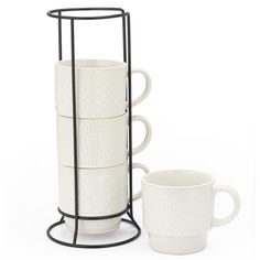 a stack of cups sitting next to each other on top of a metal stand with two mugs