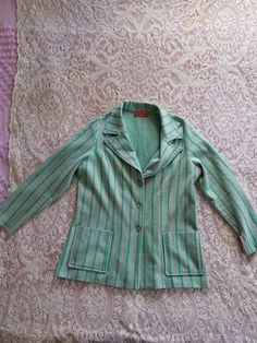 "Cute little blazer style jacket. The fabric is a poly knit that has shades of green and pink stripes. Kinda reminds me of a watermelon! Has two patch pockets on the front, and 3 buttons. Label read, \"West Coast Fashions California\" Condition: Fair to good, but definitely wearable! There is a bit of verall pilling, and a few pulls in the fabric, which isn't that noticeable. Measurements Bust: up to 41\" Length: 23\"" Casual Striped Blazer With Button Closure, Green Button-up Cotton Blazer, Spring Striped Button-up Blazer, Green Cotton Button-up Blazer, Green Collared Casual Blazer, Retro Green Button-up Outerwear, Retro Spring Blazer With Lapel Collar, Retro Lapel Collar Blazer For Spring, Retro Green Blazer For Spring