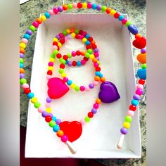 Beautifully Handcrafted Multicolored Stretchy Bracelet, Necklace And Head Band Set. Ships Asap! Makes A Great Gift For Girls Of All Ages! Cute Multicolor Plastic Necklaces, Playful Colorful Jewelry With Heart Beads, Cute Multicolor Beaded Necklaces For Parties, Multicolor Beaded Plastic Necklace, Plastic Heart Beads Jewelry For Gifts, Fun Multicolor Plastic Necklace, Adjustable Purple Playful Necklace, Playful Adjustable Purple Necklace, Playful Purple Adjustable Necklace