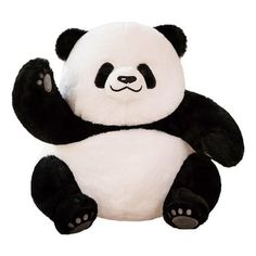 a stuffed panda bear sitting on its back with one paw in the air and eyes wide open