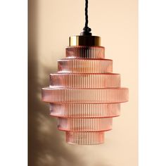 a pink glass light hanging from a ceiling