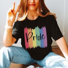 The "Pride Paint Strokes" Graphic Tee is more than just a garment; it's a vibrant celebration of diversity, love, and unity within the LGBTQ+ community. Crafted with meticulous attention to detail, this tee combines comfort with style, making it the perfect choice for expressing your pride and solidarity. The colorful rainbow paint strokes create a bold and eye-catching design, symbolizing the spectrum of identities and experiences within the LGBTQ+ community. Whether you're marching in a pride Graphic Print T-shirt For Pride, Cotton T-shirt With Rainbow Print For Pride, Relaxed Fit Crew Neck T-shirt For Pride, Trendy Crew Neck T-shirt For Pride, Trendy Multicolor Pride T-shirt, Trendy Rainbow Top For Pride, Casual Multicolor Tops For Pride, Pride Multicolor Short Sleeve Tops, Casual Rainbow Pride Tops