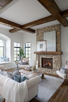 a living room filled with furniture and a fire place in the middle of a room