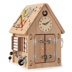 a wooden cuckoo clock with various parts attached to it's face and pendulums on the outside