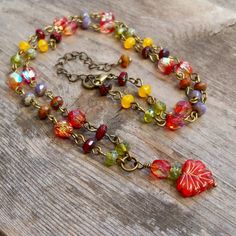 "This fun Boho-inspired necklace brings the warm colors of Autumn to any season. These gorgeous colors should not be limited to just one season a year. For those who look best in Fall and Spring colors, this necklace is for you! The slight differences in the leaf beads make this necklace a naturally unique feel. The larger leaf bead is 10 x 13mm; the smaller beads are 6mm and 3 x 5mm. All items in this series are shown in antique brass but can be made in gunmetal or silver. This necklace is 16 -