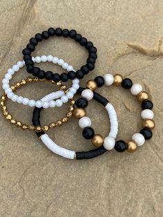 set of 5 stretch bracelets...  Top quality stretch cord  black pearly white & black wooden beads (10mm) black wooden beads (8mm) gold faceted acrylic beads (6mm) pearl acrylic beads (6mm) black and white block style pattern  This set measures 7.25 inches.. if you need a different size, just measage me~ please note the pattern of the multi colored (10mm) bracelet would be altered to accomodate the size change.  sizing guidelines Bracelet length:  Standard X-Small ~ 6.5 inches Standard small ~7 in Cheap Black Beaded Bracelets With Colorful Beads, Stacking Bracelets, White Bracelets, Block Style, Stackable Bracelets, Beaded Keychains, Car Charms, Everyday Jewelry, Acrylic Beads