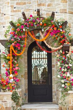 an entrance decorated with flowers and greenery