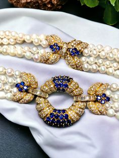 An absolutely spectacular Italian made necklace done in 18K yellow gold and strung together with 5.95mm cultured pearls. All sections of this necklace are adorned with F-G color Vs1-2 clarity round and baguette diamonds having a total approximate weight of 8.40cttw. Let's not forget about the stunning royal blue round cut sapphires both in the centerpiece as well as the clasp. All sapphires are natural and have an approximate weight of 11.70cttw. Striking would be an understatement. By Italian m Luxury Pearl Necklace With Gemstones For Formal Occasions, Exquisite Sapphire Necklace, Luxury Sapphire Gemstone Beads Necklace, Luxury Sapphire Necklace With Polished Finish, Luxury Akoya Pearl Gemstone Necklace, Exquisite Luxury Sapphire Necklace, Luxury Exquisite Sapphire Necklace, Italian Necklace, South Seas