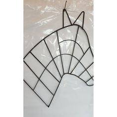 a metal horse head is shown against a white background with plastic bags behind it and the image has been altered to look like stained glass