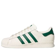 The Adidas Superstar 82 'White Dark Green' is a classic sneaker with a modern twist. Its timeless silhouette features a rubber sole and a white upper with a dark green accent. Inspired by vintage aesthetics, this sneaker is perfect for everyday wear and sports activities. The 'White Dark Green' is part of the iconic Superstar series, a timeless classic that will never go out of style. Whether you’re looking for a classic sneaker or a modern twist, the Adidas Superstar 82 'White Dark Green' is th Adidas Superstar Green, Adidas All Star, Superstar Adidas, Green Adidas, Vintage Aesthetics, Adidas Originals Superstar, Green Accents, Classic Sneakers, Sports Activities