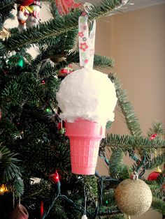 an ice cream cone ornament hanging from a christmas tree